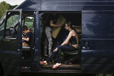Irish traveller children play together in the family's Transit van as they pass through Yorkshire.
