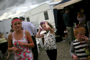 Mary Ann Sheridan and her family celebrate at their cousin Kaitlin's first birthday party on a stormy day at Dale Farm, an Irish Travellers' site on a former scrapyard in Essex.