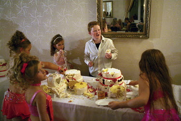 Irish Traveller children demolish a wedding cake at a raucous wedding reception party held at The Thurrock Hotel in Essex.