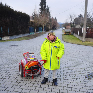 Milena (48), who distributes circular ads and supermarket flyers, with her cart.