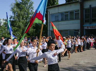 Students of the school N9 carry the state and regional flags during the Last Bell ceremony, at the end of the school year.
