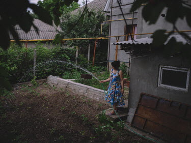 Angela, watering her vegetable garden.