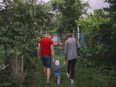 Katrine, Alexander and his nephew walk in the garden at Alexander's grandparents house.