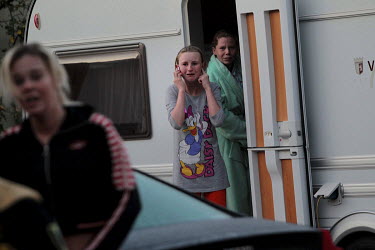 Vallen Sheridan, her sister Savannah behind, cries as she stands in the doorway of her trailer during the mass eviction, ordered by Basildon Council, of the Dale Farm Irish Travellers' site.