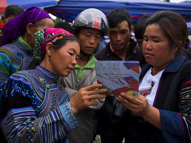 A woman comes forward at Bac Ha Market to tell Suong (R), an activist against people trafficking, of her own experience, her daughter has been missing for a year thought to be kidnapped and taken over...
