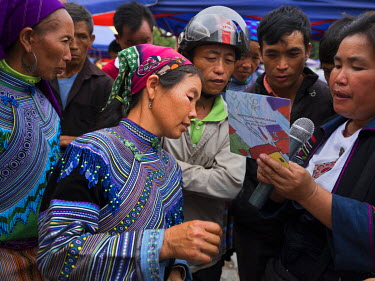 A woman comes forward at Bac Ha Market to tell Suong (R), an activist against people trafficking, of her own experience, her daughter has been missing for a year thought to be kidnapped and taken over...
