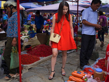 A woman looks at produce for sale in Bac Ha Market.