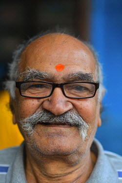 A Hindu man with a Bindi (red spot) on his forehead.