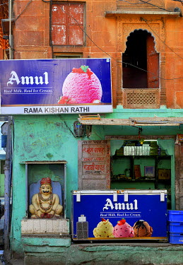 A neighbourhood shrine and an ice cream shop share the same building.