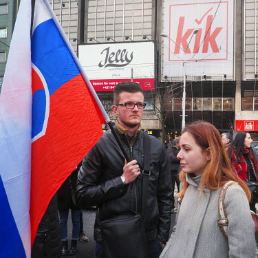 A protester with Slovakian flag at a rally under the slogan 'Postavme sa za slusne Slovensko' (Let's stand for a decent Slovakia). Mass protests broke out in response to the murder of journalist Jan K...