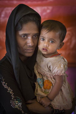 Zan Mal Lida with her daughter, one year old Remus, who has been ill for days and was brought in to the health centre at the Hakinpara Rohingya refugee camp where there are many children suffering fro...