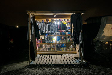 A makeshift shop, selling clothes, mobile phones etc, opened in the so-called 'Jungle' refugee camp.