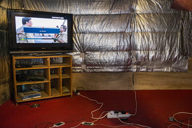 A television in a makeshift restaurant in the so-called 'Jungle' refugee camp.