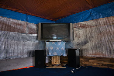 A huge television in a makeshift restaurant in the so-called 'Jungle' refugee camp.