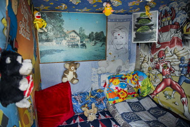 A bedroom in a makeshift shelter in the so-called 'Jungle' refugee camp decorated with donated toys and blankets.