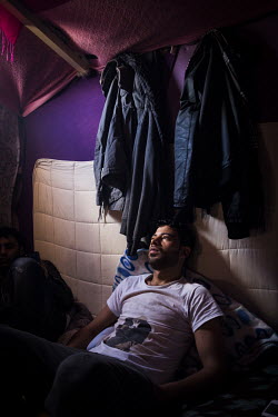 Ibrahim, a Syrian refugee living in a makeshift shelter in the so-called 'Jungle' refugee camp. Eventually he made it to the UK where he moved in with relatives.
