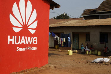 An advertisement for Huawei mobile phones painted on the side of a building.