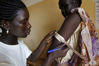 A refugee has her upper arm measured as part of a malnutrition prevention program at Kiryangondo refugee camp.