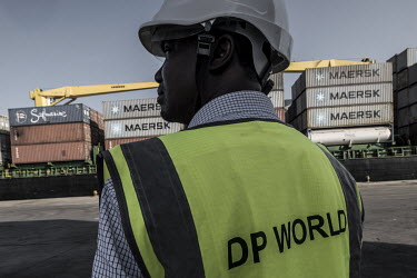 An official from the Dubai-based company, DP World, oversees the onloading of a container vessel at the port in Berbera.