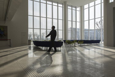 A man walks through the lobby of a building on the campus of Duke Kunshan University.