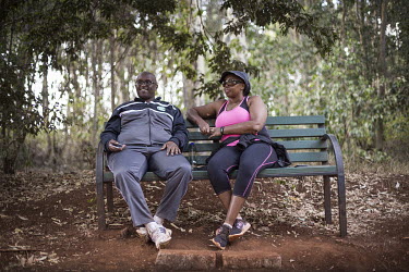 A couple take a break during a walk in the Karura Forest.