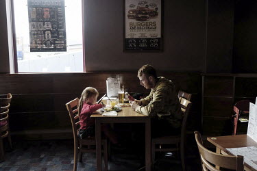 Andrew and his daughter Imogen share a breakfast at the Wetherspoons pub in Peterlee, the biggest town in East Durham. Wetherspoons is a public house chain where cheap beer and food are available and...