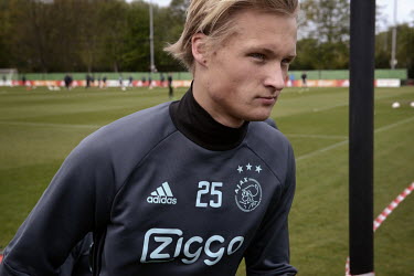 Kasper Dolberg, a forward with football club AFC Ajax, leaves the pitch after training.