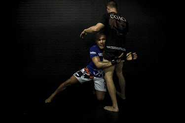 American Roger Huerta (blue shirt), a professional mixed martial arts fighter with nearly 30 professional fights under his belt, coaching at the legendary Tiger gym on Soi Tad, or 'Gym Road', a single...