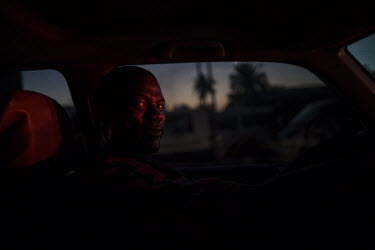 Pastor Emmanuel Momoh in his car after a church service in Freetown. He was one of the excavating team that discovered the world's 14th largest diamond in 2017. Instead of selling the stone on the bla...