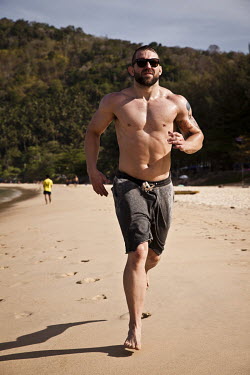 Alan Belcher, an American mixed martial artist figther, training on the beach.