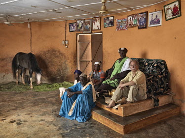 Yakubu Abdulai, member of the Andani family, (dob. Aug. 5, 1949), a Dagomba subdivisional chief (Nyankpala Lana) with members of his court, his horse and photographer Jan Banning.  The Sweating Subjec...