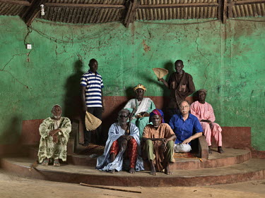 Abubakari Yakubu (dob Nov. 28, 1955), from the Abudu family, a Dagomba chief (Gushiegu Naa) with members of his court and photographer Jan Banning.      The Sweating Subject is a small series of portr...