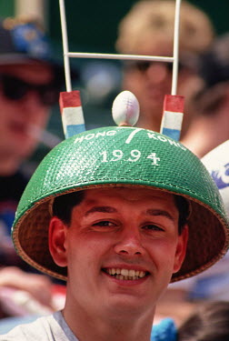 A fan wearing an elaborate hat attends the HK Rugby Sevens tournament.