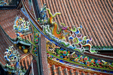 A detail of the decorative ceramic tiles on the roof of the Bao An Temple. The temple was constructed in 1742 and inducted into UNESCO for cultural heritage conservation in 2003.