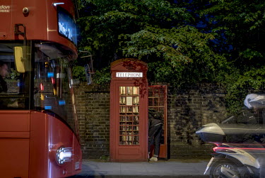 A red bus passes a telephone kiosk in Lewisham that has been turned into a community library. The K2 variant of the iconic General Post Office red telephone box is rare enough for all surviving models...