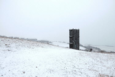 Snow falls around a pit cage that once carried men deep underground to the coal mine in Easington Colliery. The mine provided employment for 86 years, until it's closure in 1993.