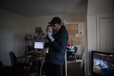 Andrew holds his baby son William at their home in Easington Colliery. Like many in the area the family's home is provided through the housing association which owns many of the town's former pit cott...