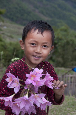 A young boy with flowers.