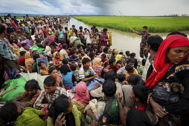 A Bangladeshi soldier tries to direct a crowd of Rohingya refugees as they flee into Bangladesh.    Following attacks by Rohingya militants against several police posts on 25 August 2017 hundreds of t...