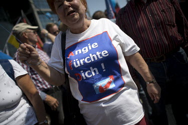 A woman with a t-shirt with the slogan 'Angie fuerchte Dich' (Angie (Merkel) be afraid) during an AfD (Alternative fuer Deutschland) rally under the slogan 'Zukunft Deutschland' (Future Germany) makes...