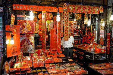 The owner of a small shop selling traditional Chinese New Year calligraphy and other auspicious materials, stands at the entrance of his store on Dihua Street. One of the oldest trading streets in Tai...