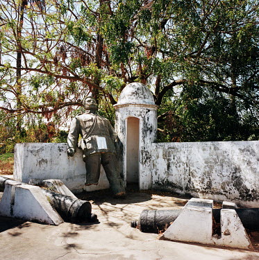 A statue of Texeira Pinto, a Portuguese military administrator, lies broken in the grounds of an fort, now an open-air museum housing various old colonial-era statues.