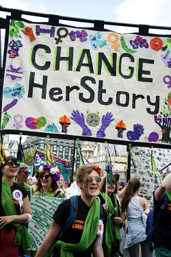 A banner reads: 'Change her story' as women gathered to take part in 'Processions', a mass participation artwork, and rally, produced by Artichoke and commissioned by 14-18 NOW to celebrate 100 years...