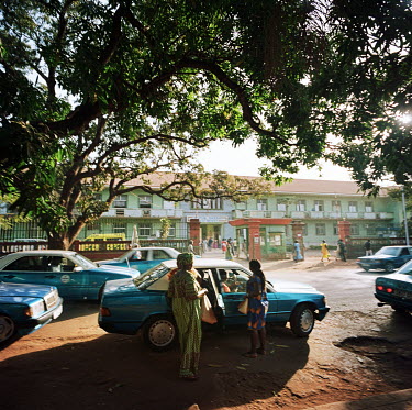 Women arriving by taxi at the central hospital, Simao Mendes, early in the morning.