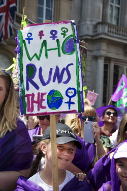 A girl with a placard that reads: 'Who Runs The [World]', takes part in 'Processions', a mass participation artwork, and rally, produced by Artichoke and commissioned by 14-18 NOW to celebrate 100 yea...
