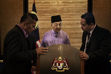 Prime Minister, Mahathir Bin Mohamad, looks over his speech as he records an Eid message in the Prime Minister's Office.