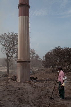 Juan Ortiz (63), from nearby El Barrio, stands on roughly four metres of volcanic ash where the home of his son Jesus Ezequiel Ortizon has been buried following the eruption of the Fuego Volcano. He s...