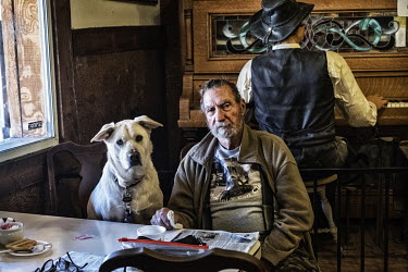 The owner of the TE Olive restaurant and his dog.