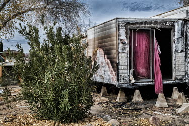 A burnt out caravan in a trailer park.