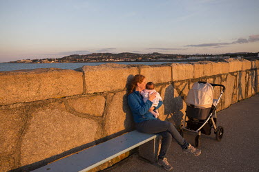 Catherine Darker holds six week old daughter Amelia at sunset on the east pier at Dun Laoghaire (Dunleary).